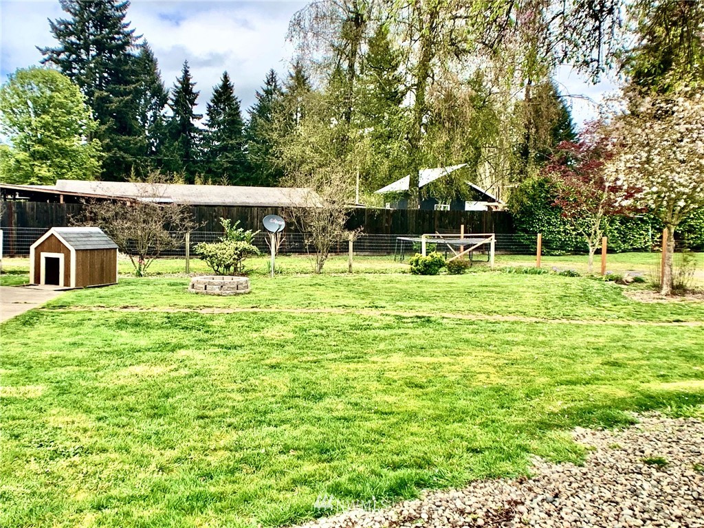 17734 Jordan Street Southwest Rochester, WA 98579 - Photo 22 of 27 a backyard of a house with table and chairs
