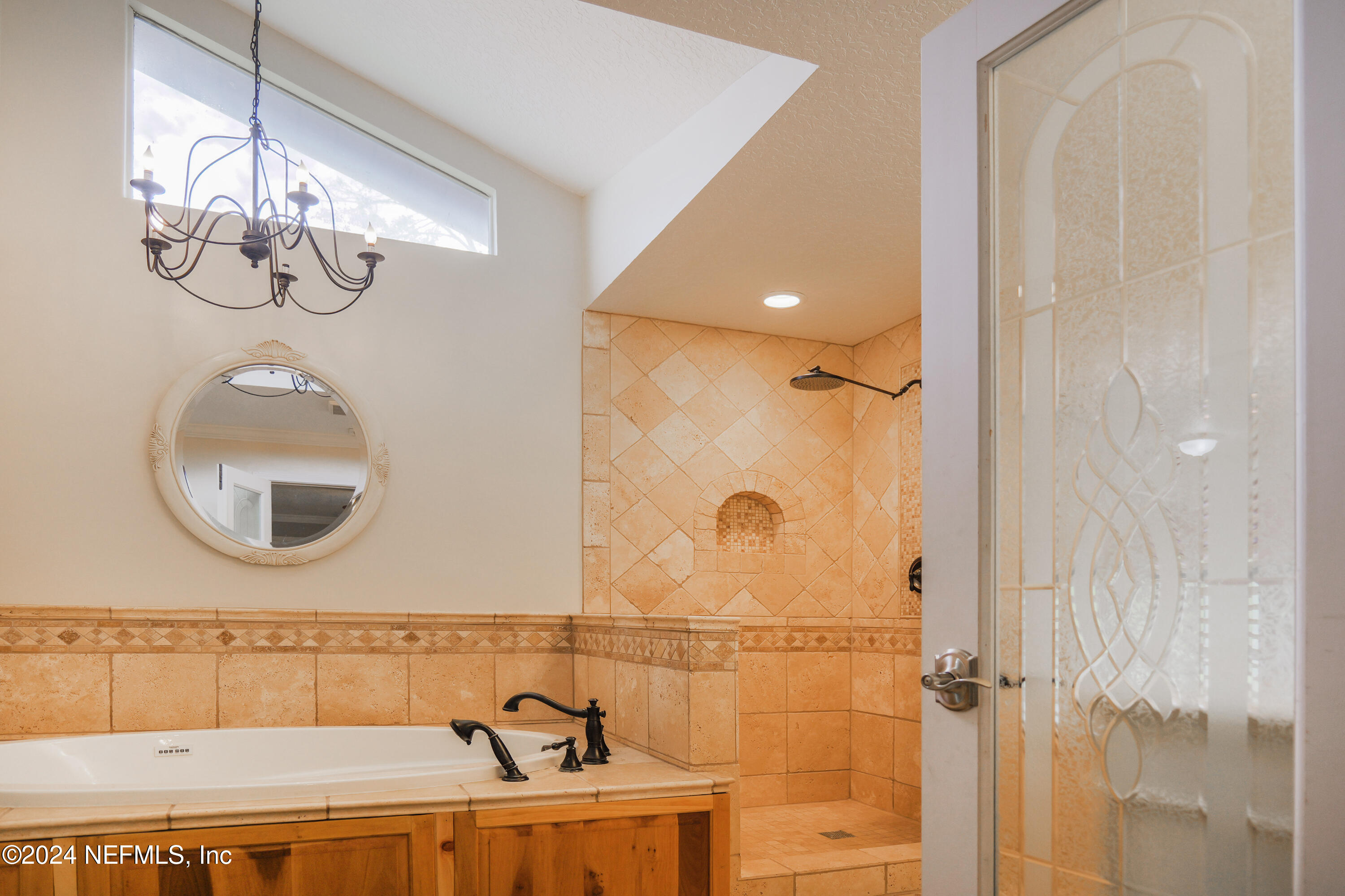 6566 Sherry Lane St. Augustine, FL 32095 - Photo 12 of 24 a bathroom with a sink a mirror and a shower