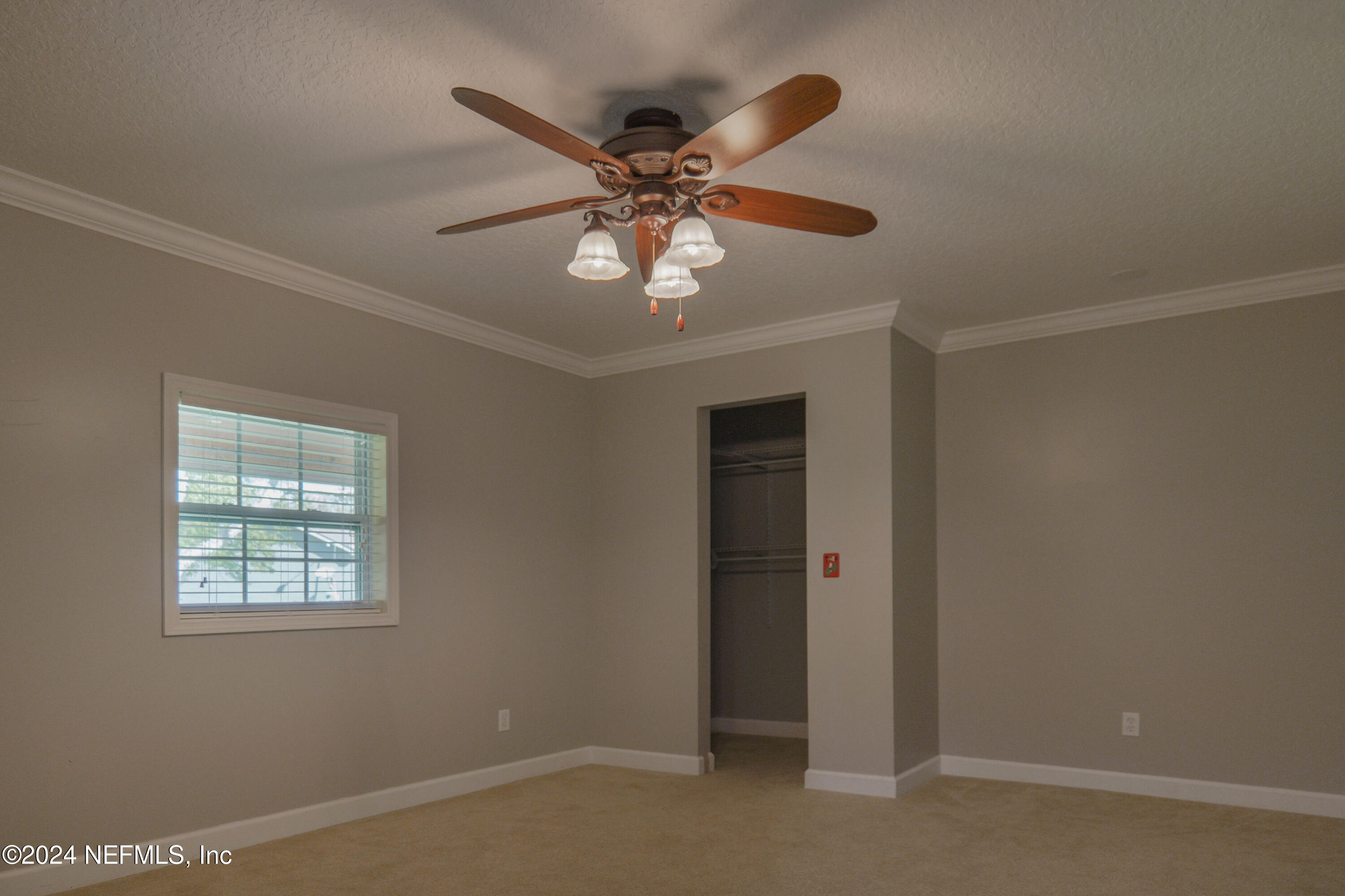 6566 Sherry Lane St. Augustine, FL 32095 - Photo 14 of 24 an empty room with windows and ceiling fan