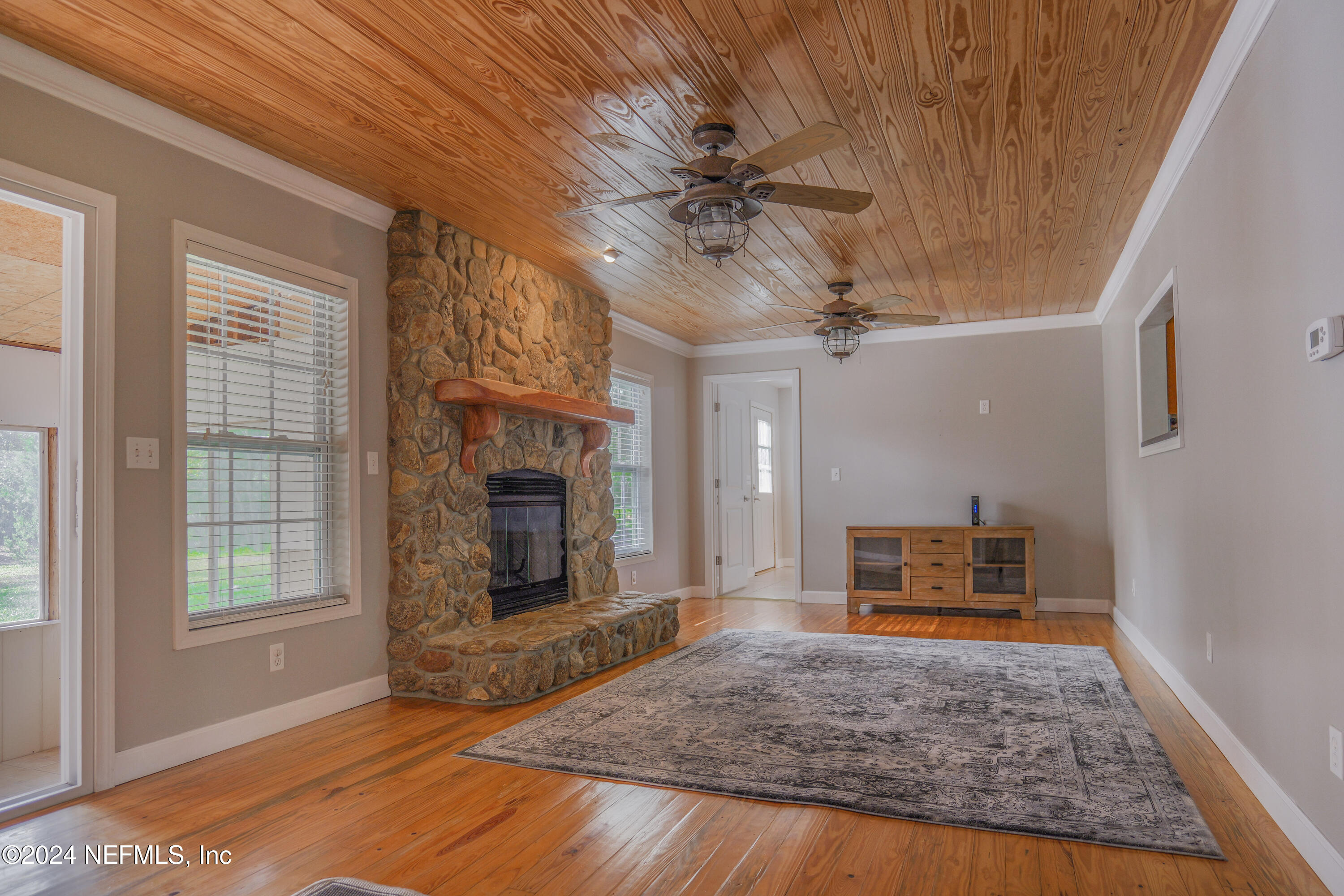 6566 Sherry Lane St. Augustine, FL 32095 - Photo 9 of 24 a living room with furniture a fireplace and a window