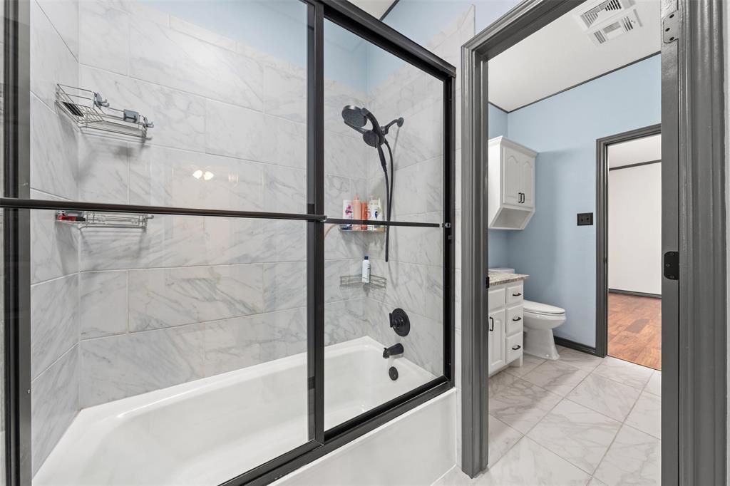 3091 Rockbridge Road McGregor, TX 76657 - Photo 31 of 40 a bathroom with a glass shower door