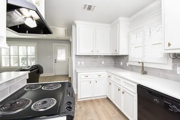 a kitchen with a stove and a sink