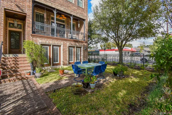 a view of a backyard with table and chairs and wooden fence