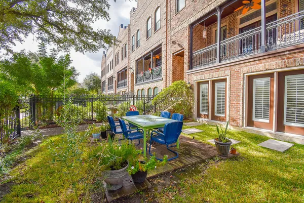 a view of a house with backyard sitting area and garden