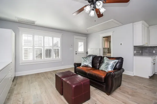 a living room with furniture and wooden floor