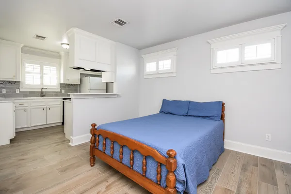 a kitchen with stainless steel appliances a sink cabinets and wooden floor