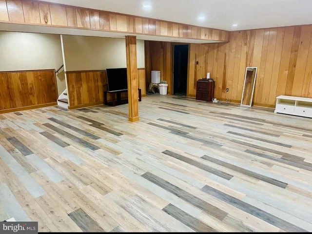 a view of a livingroom with furniture and staircase