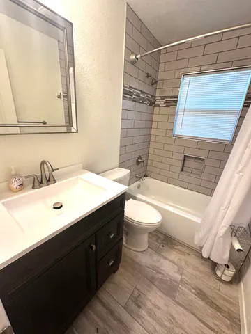 a view of bathroom with a tub and hardwood floor