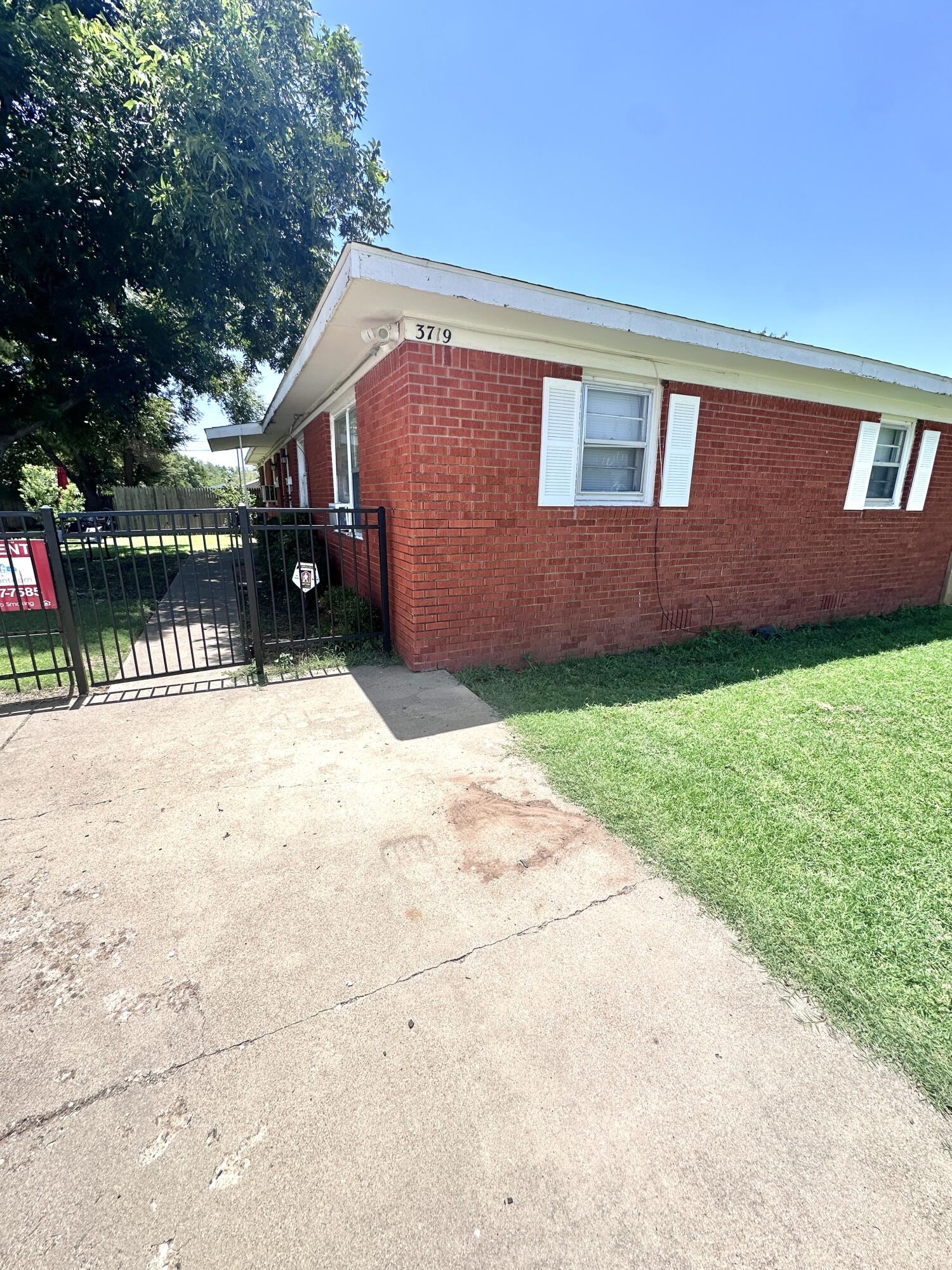 3719 30th Street, Unit A Lubbock, TX 79410 - Photo 2 of 16 a front view of a house with a yard