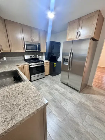 a kitchen with a refrigerator and a stove