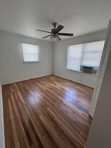 a bedroom with a bed and a ceiling fan