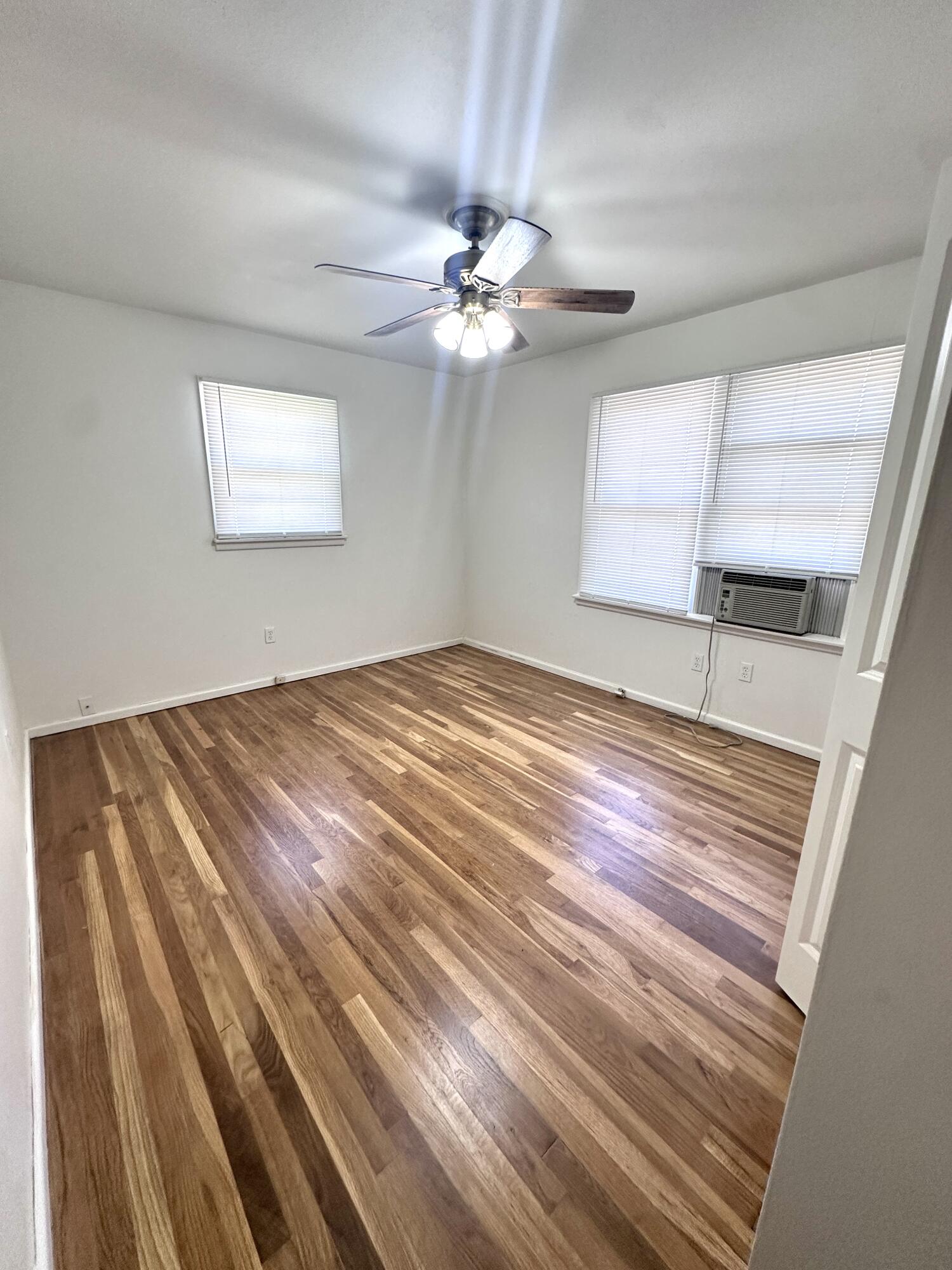 3719 30th Street, Unit A Lubbock, TX 79410 - Photo 8 of 16 a bedroom with a bed and a ceiling fan