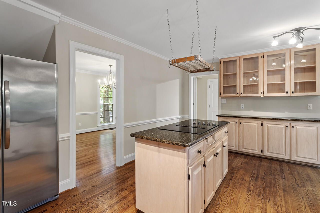 5200 Smallwood Court Raleigh, NC 27613 - Photo 11 of 38 a kitchen with stainless steel appliances granite countertop a stove and a wooden floors