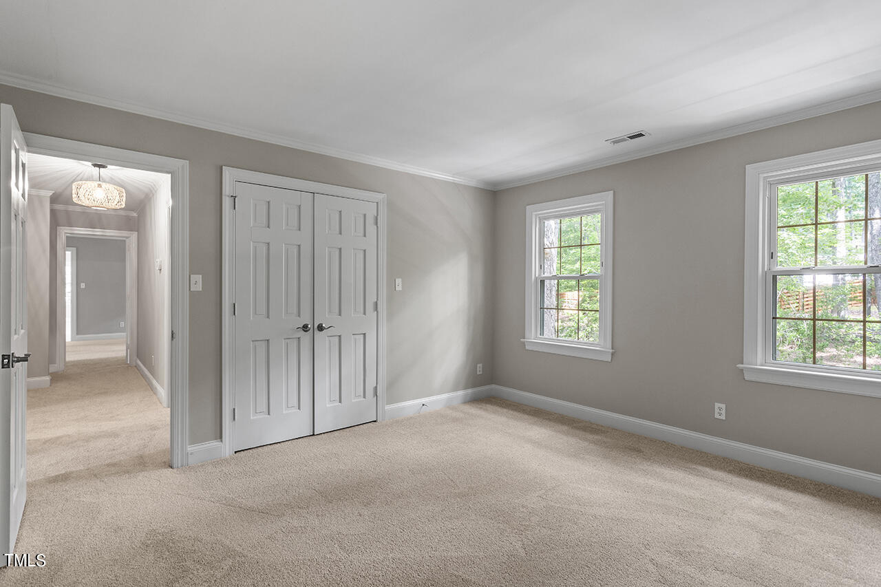 5200 Smallwood Court Raleigh, NC 27613 - Photo 21 of 38 an empty room with windows and closet