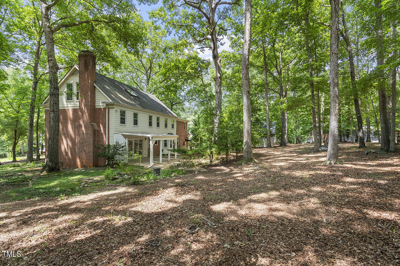 5200 Smallwood Court Raleigh, NC 27613 - Photo 32 of 38 a house with trees in front of it