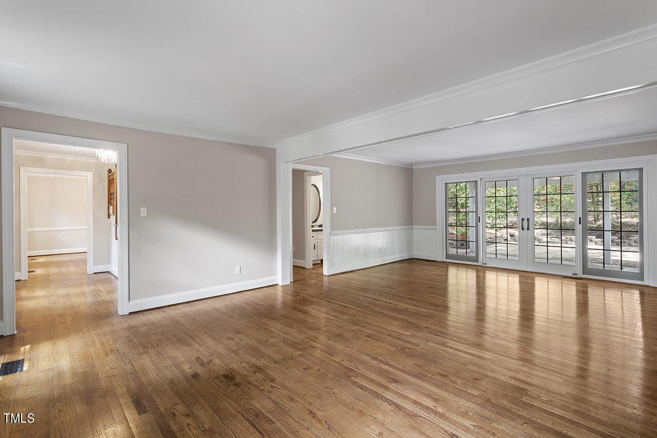 5200 Smallwood Court Raleigh, NC 27613 - Photo 6 of 38 wooden floor in an empty room with a window