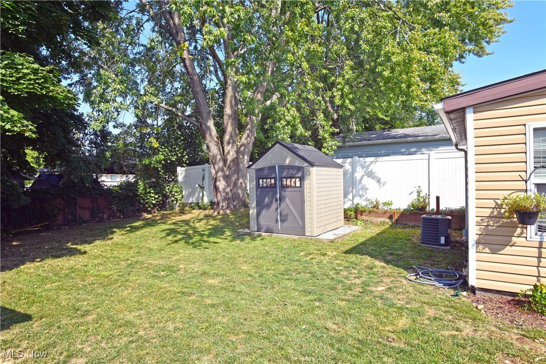 464 Stanley Road Akron, OH 44312 - Photo 24 of 25 View of yard featuring central AC unit and a storage unit