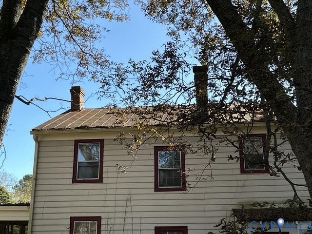 1633 Stuart Avenue Petersburg, VA 23803 - Photo 20 of 28 View of side of property featuring a chimney