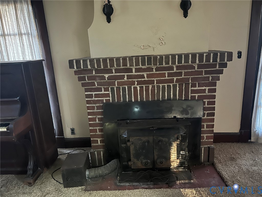 1633 Stuart Avenue Petersburg, VA 23803 - Photo 28 of 28 Detailed view of carpet and a brick fireplace