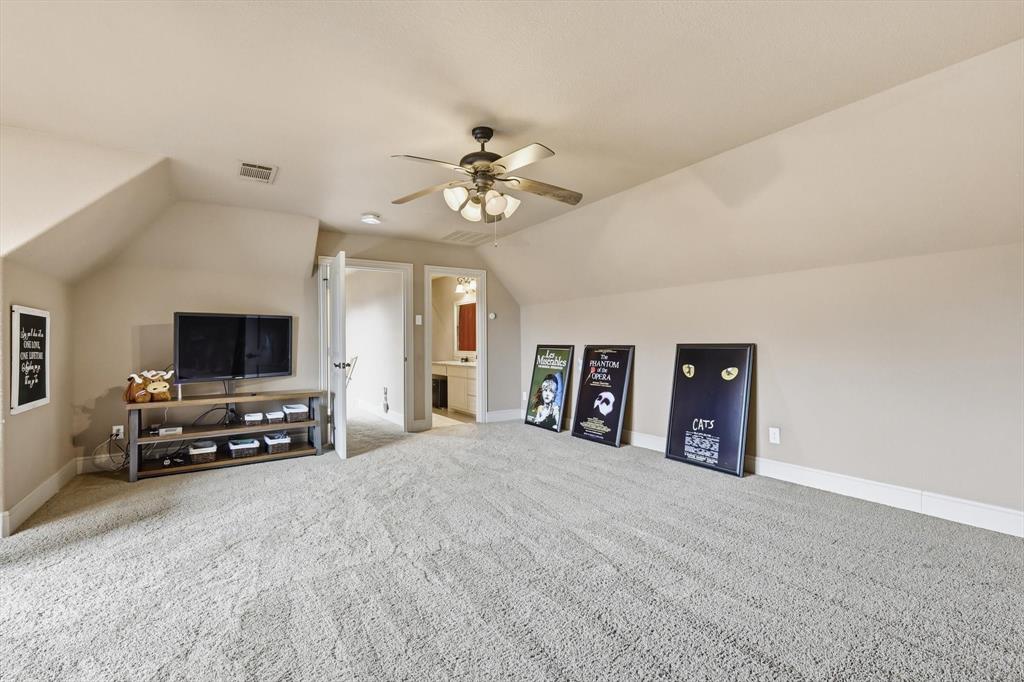406 Spurgin Road Lucas, TX 75002 - Photo 24 of 39 Additional living space featuring vaulted ceiling, ceiling fan, and light carpet