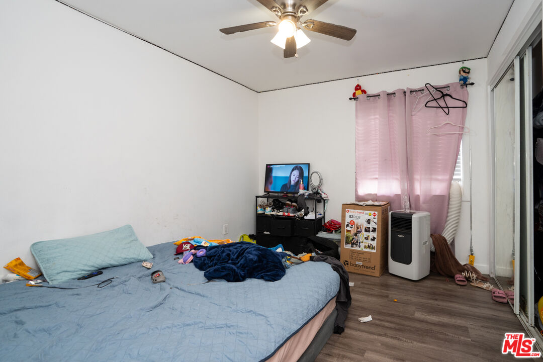 1047 East 33rd Street Los Angeles, CA 90011 - Photo 12 of 24 a bedroom with a bed and a flat tv screen on a dresser