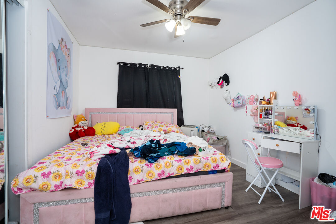 1047 East 33rd Street Los Angeles, CA 90011 - Photo 13 of 24 a bedroom with a bed and a table in it