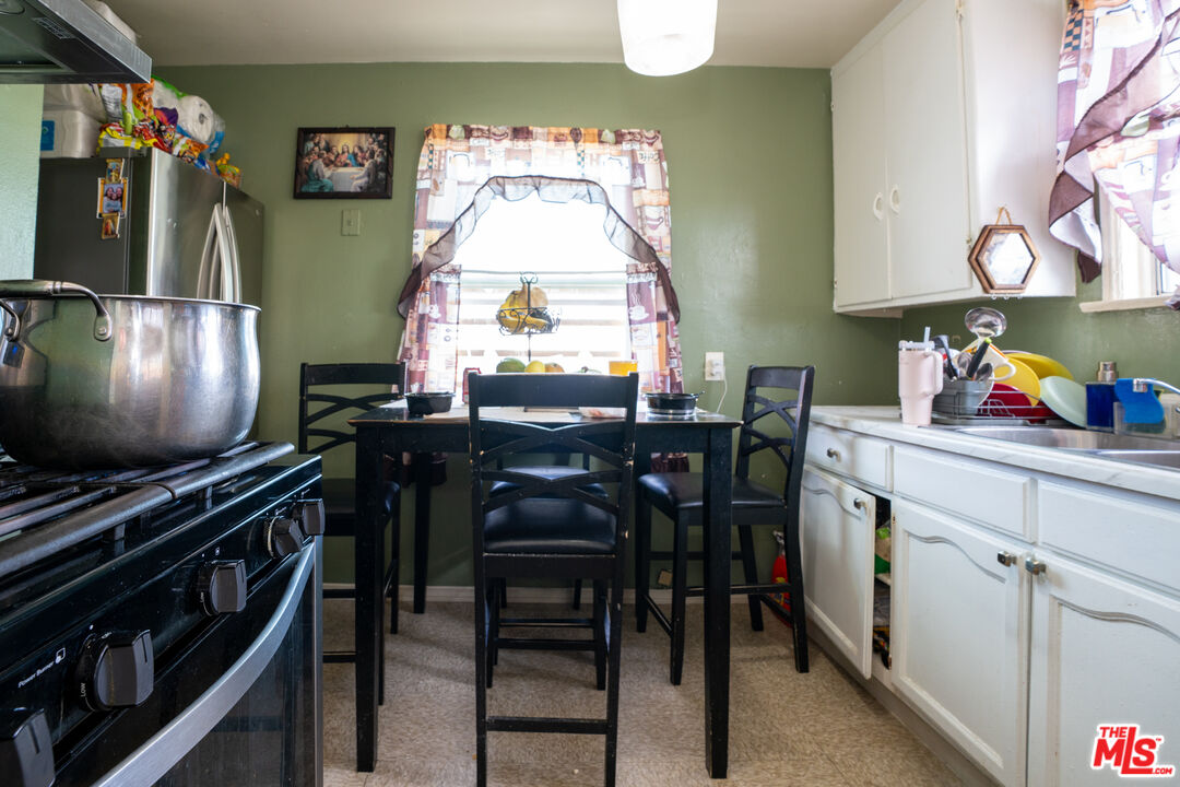 1047 East 33rd Street Los Angeles, CA 90011 - Photo 16 of 24 a kitchen with stainless steel appliances a stove a sink dishwasher and a refrigerator