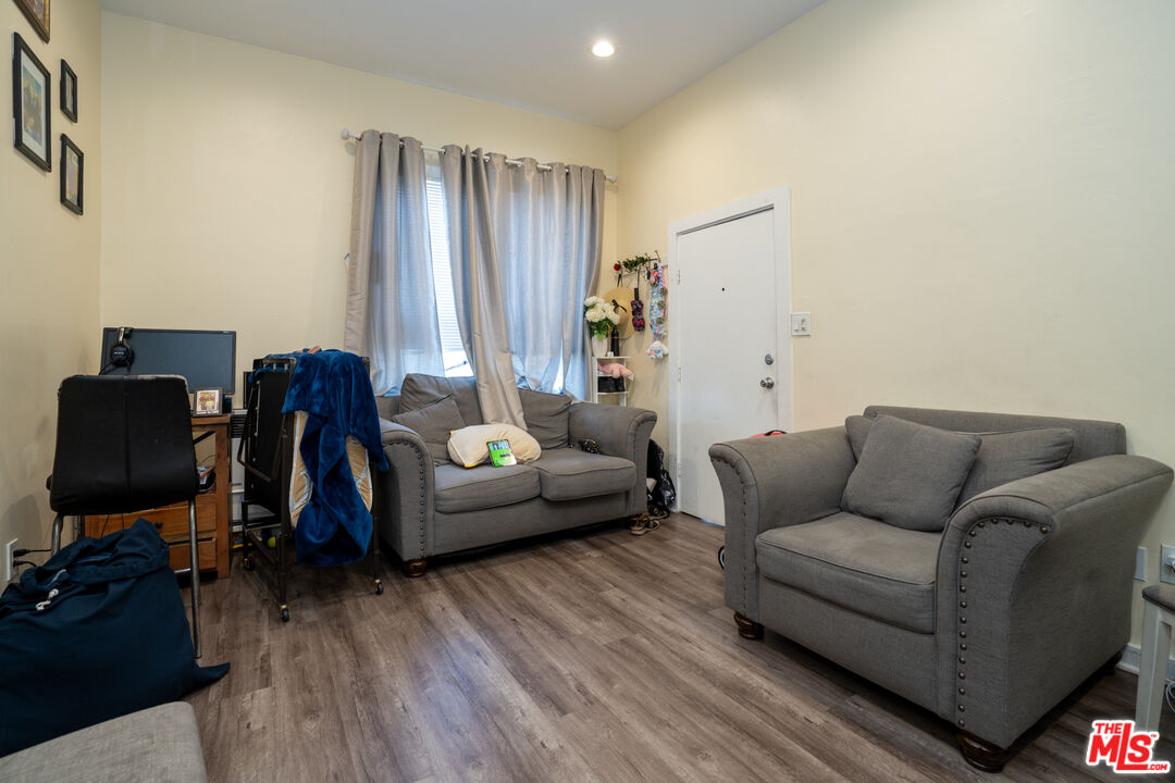 1047 East 33rd Street Los Angeles, CA 90011 - Photo 23 of 24 a living room with furniture and wooden floor