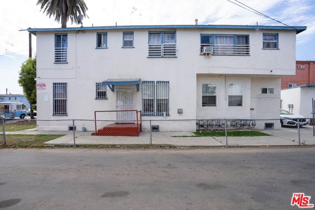 1047 East 33rd Street Los Angeles, CA 90011 - Photo 8 of 24 a house with palm tree in front of it