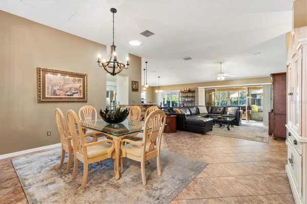 a dining room with furniture a chandelier and window