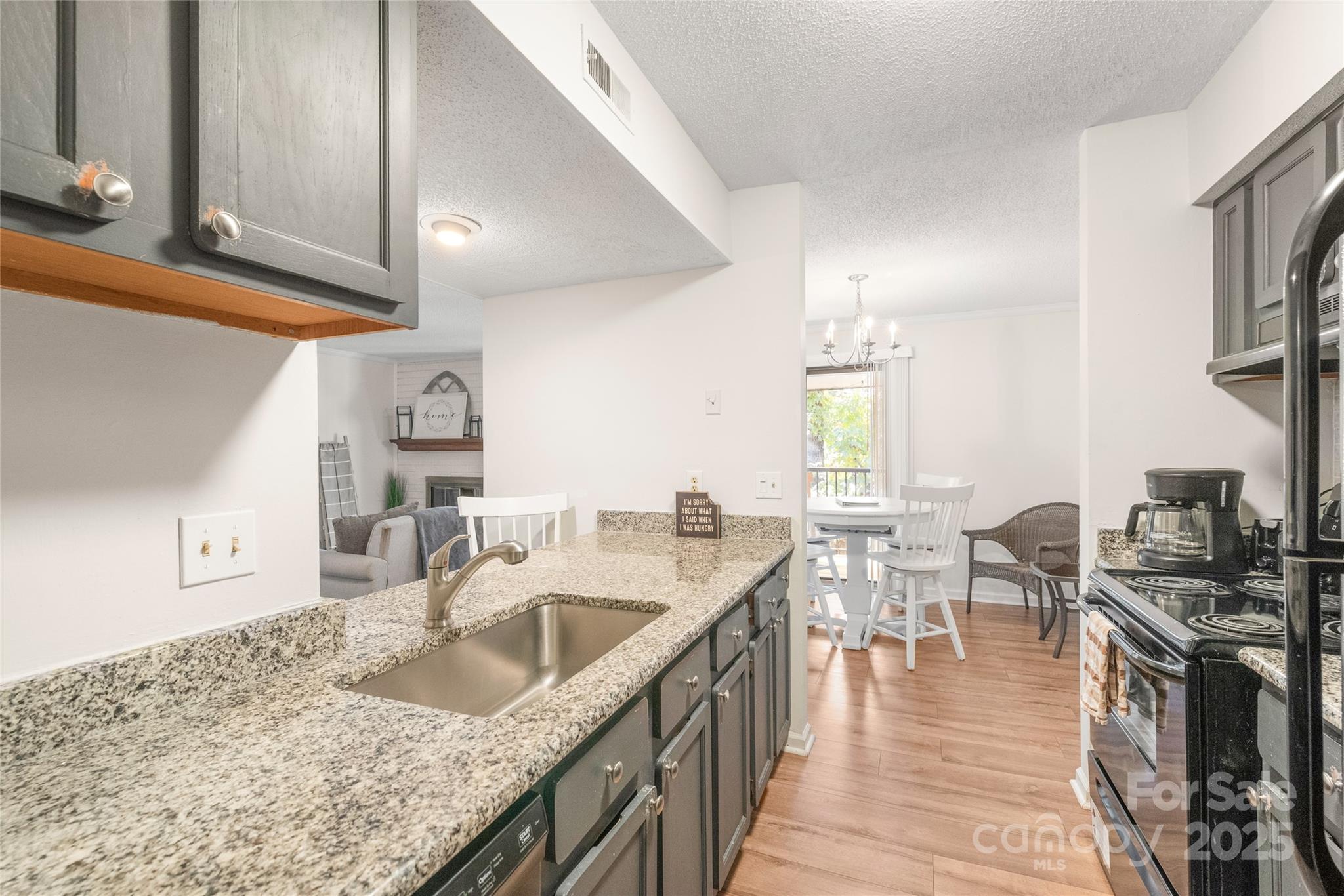 11058 Cedar View Rd. Charlotte, NC 28226 - Photo 16 of 28 a kitchen with granite countertop a sink a stove and cabinets