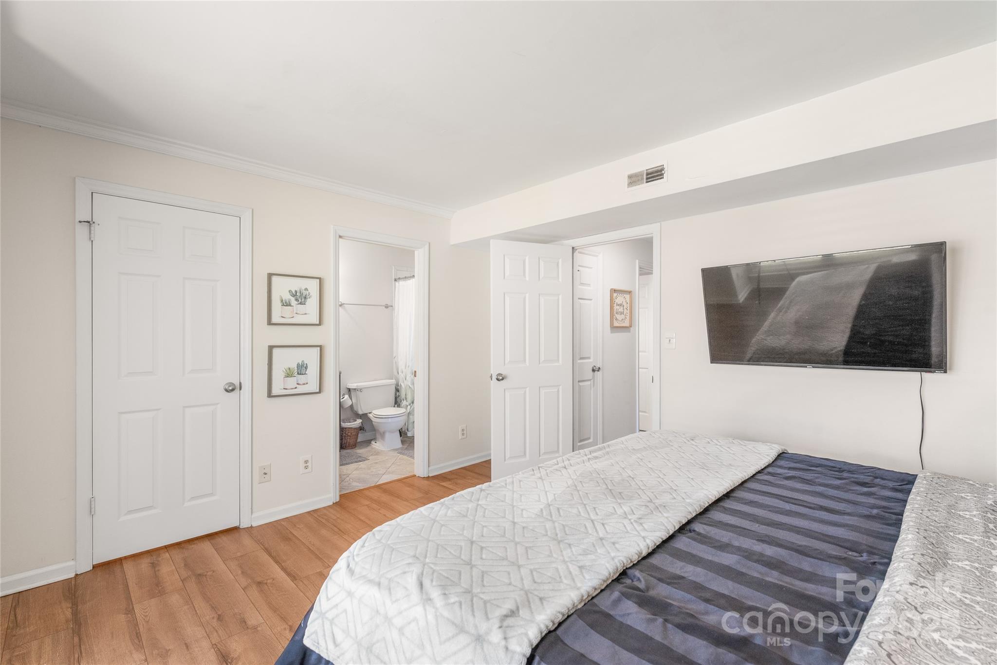 11058 Cedar View Rd. Charlotte, NC 28226 - Photo 18 of 28 a bedroom with a bed and a television