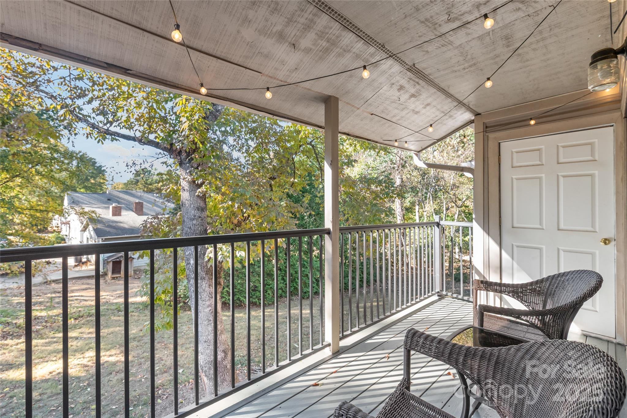 11058 Cedar View Rd. Charlotte, NC 28226 - Photo 24 of 28 a view of a chair and table in the balcony