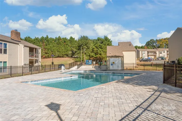 a view of a house with swimming pool and sitting area