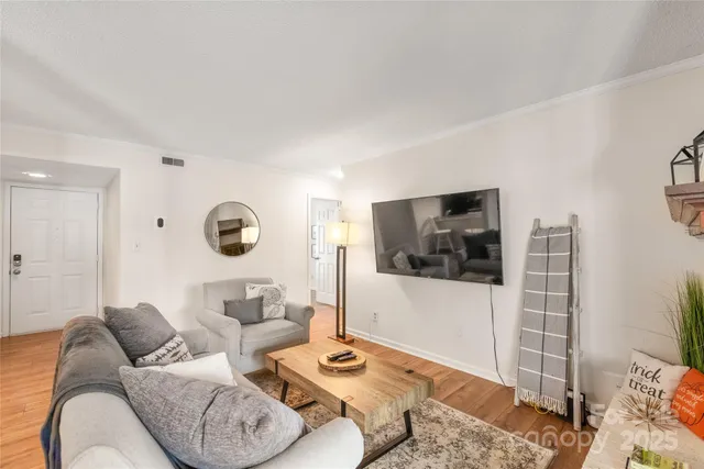 a living room with furniture and a flat screen tv