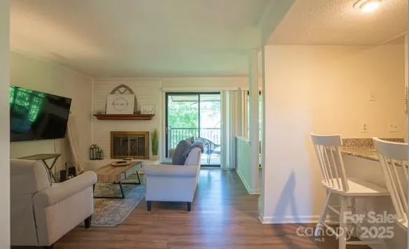 a living room with furniture a fireplace and a flat screen tv