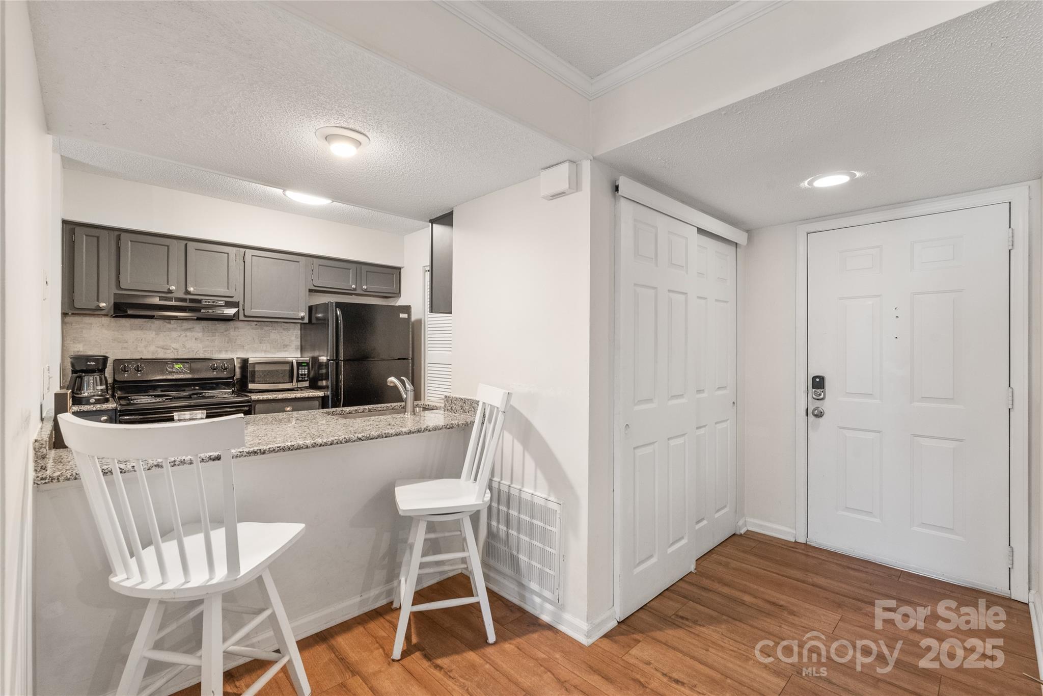 11058 Cedar View Rd. Charlotte, NC 28226 - Photo 10 of 28 a kitchen with stainless steel appliances a microwave a stove a refrigerator and cabinets