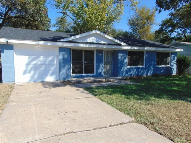 a front view of a house with a garden and patio