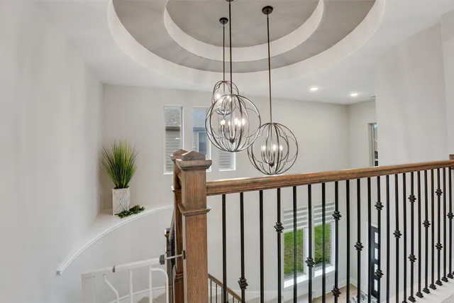a view of a hallway with wooden floor and entryway