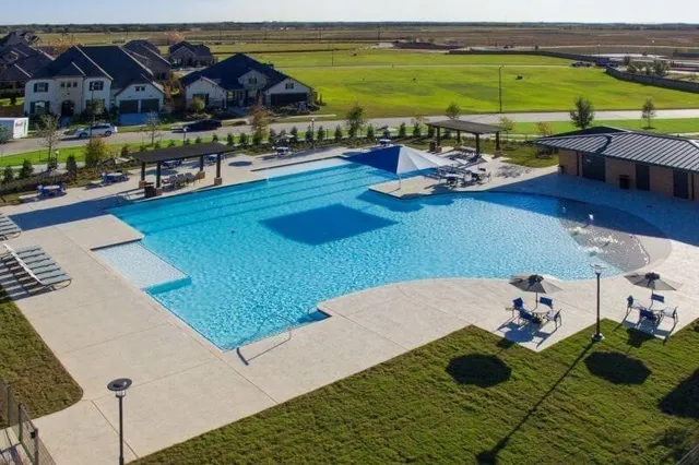 a view of a swimming pool with lawn chairs