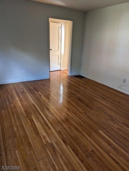 364 Orange Road, Unit B5 Montclair, NJ 07042 - Photo 3 of 5 a view of an empty room with wooden floor and a window