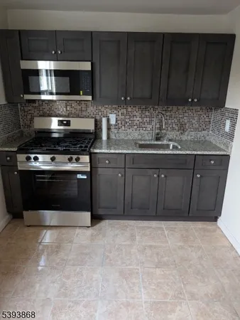 a kitchen with a stove and a microwave