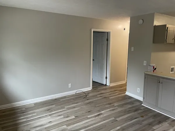 a kitchen with granite countertop a refrigerator and a stove top oven