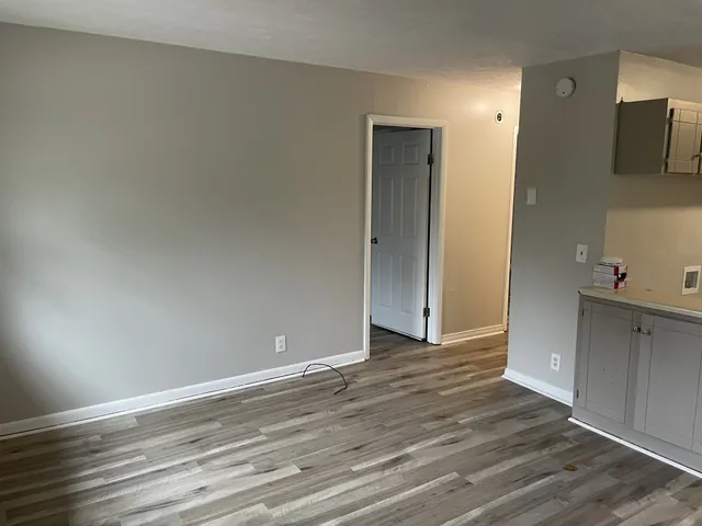 a kitchen with granite countertop a refrigerator and a stove top oven