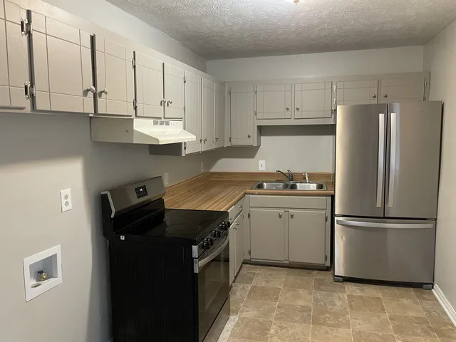 a view of a room with wooden floor and a ceiling fan
