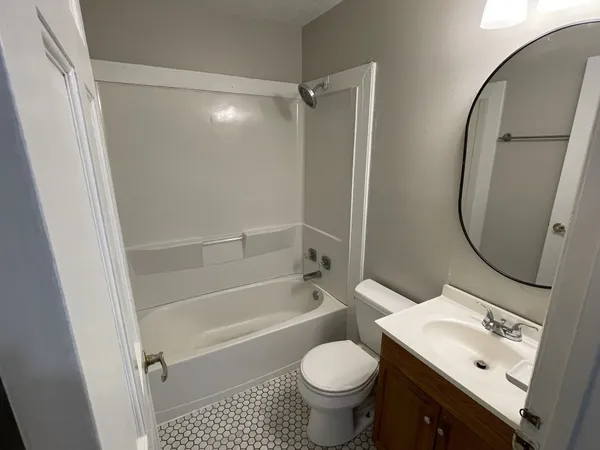 a bathroom with a sink toilet vanity and shower