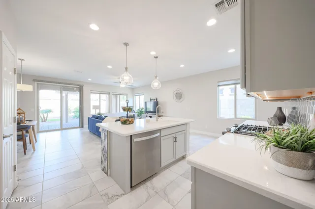 a living room with furniture and kitchen view