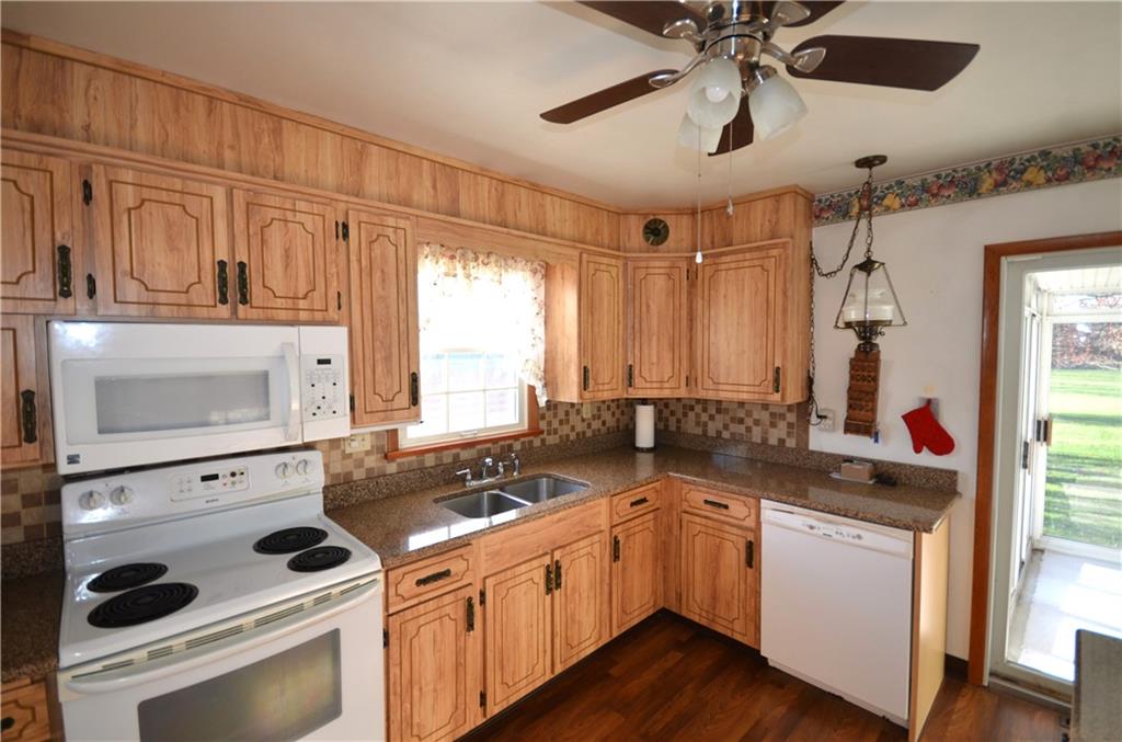 123 Jackson Street Harmony, PA 16037 - Photo 8 of 10 a kitchen with a stove a sink and a microwave