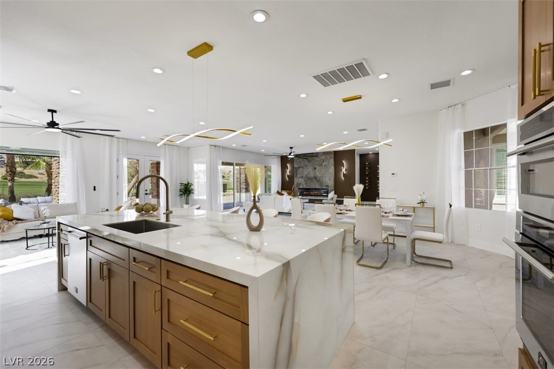 5015 Rivedro Street Las Vegas, NV 89135 - Photo 12 of 91 Culinary delights await in this bright kitchen with a spacious island, modern appliances, and seamless open-concept living.