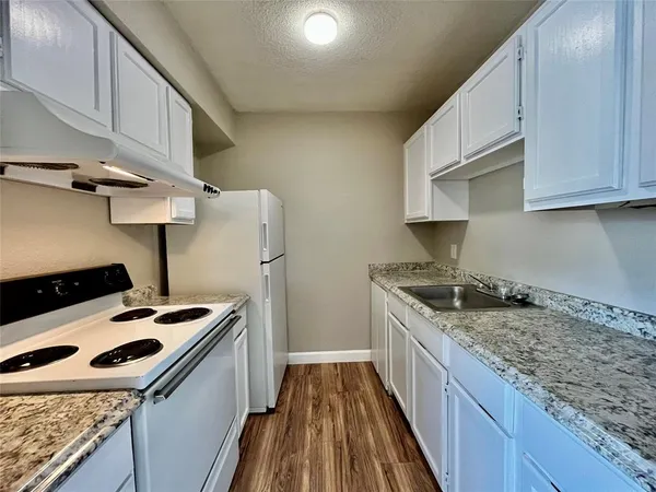 a kitchen with a stove and a sink